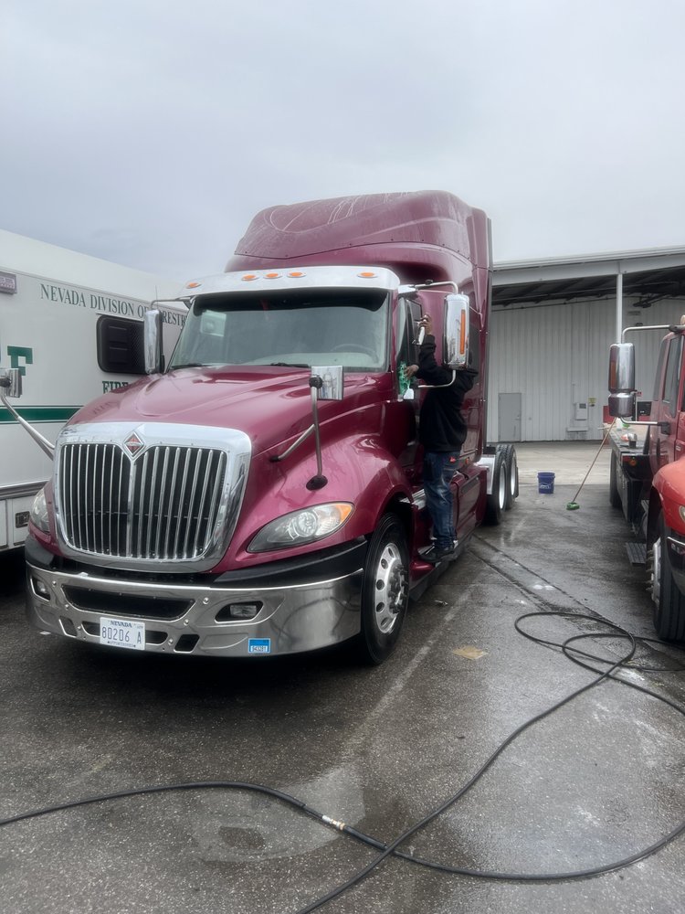 Team hand-washing semi-truck cab on-site