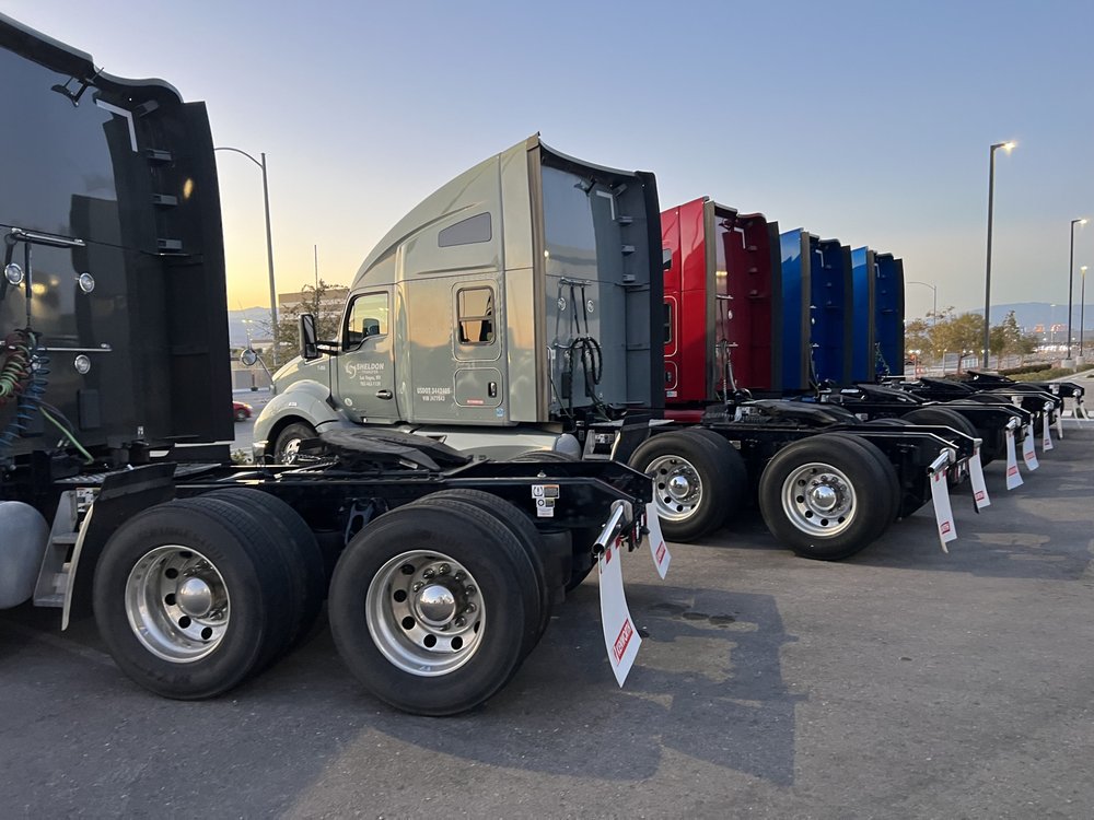 Fleet of semi-trucks lined up after full wash service